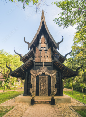 This image shows the Black House Museum (Baan Dam) in Chiang Rai, created by Thai artist Thawan Duchanee. The dark, mysterious buildings are filled with unique art and sculptures, offering a thought-provoking experience that explores themes of death and spirituality.