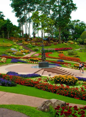 This image shows the Doi Tung Royal Villa in Chiang Rai, Thailand, surrounded by lush gardens and offering panoramic views of the surrounding mountains. The villa, once home to the Thai royal family, is now a peaceful destination for visitors interested in history and nature.