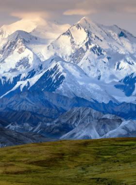 This image shows that Denali is the tallest mountain in North America, located in the heart of Denali National Park. The photograph captures Denali’s majestic peak, rising above the Alaskan wilderness. Whether viewed from Anchorage or within the park, the sight of Denali is awe-inspiring. The surrounding landscapes, including glaciers, forests, and rivers, create a stunning backdrop. Denali is a dream destination for hikers, mountaineers, and photographers, offering unparalleled natural beauty and an unforgettable experience for outdoor enthusiasts.