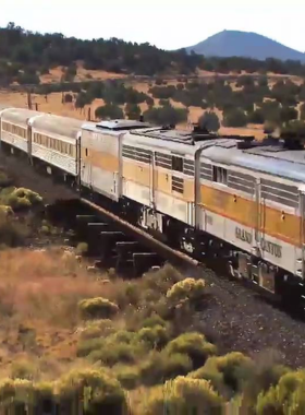 This image shows the Grand Canyon Railway, a scenic train ride offering a relaxing and nostalgic journey into the heart of the Grand Canyon. Passengers on the train enjoy beautiful views of the canyon’s surroundings as they travel in comfort and style. The historic railway offers an alternative way to reach the canyon and is an enjoyable experience for those who prefer a laid-back travel option while taking in the incredible scenery of the region."