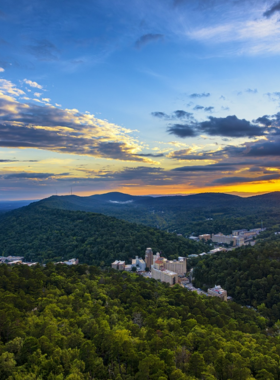 This image shows the breathtaking views from the top of the Hot Springs Mountain Tower, a popular tourist attraction in Hot Springs, Arkansas. The tower offers 360-degree panoramic views of the surrounding Ouachita Mountains and Lake Hamilton. Visitors can take in the vast landscape, capturing photos or simply enjoying the beauty of the area. This image showcases the incredible vantage point from the tower, offering a stunning way to see Hot Springs and its surrounding natural wonders from above.