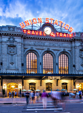 This image shows Denver's iconic Union Station, featuring its beautiful Beaux-Arts architectural design. The station has been transformed into a vibrant hub, complete with shops, cafes, and restaurants. It’s a popular gathering spot for locals and visitors alike, offering a unique blend of history and modern amenities. Visitors can relax in the station's grand interior while enjoying a meal or coffee or explore the surrounding neighborhoods. Union Station is both a transit point and a cultural landmark in downtown Denver.