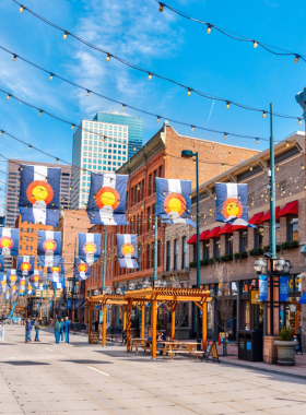 This image shows the charming historic Larimer Square in downtown Denver, featuring cobblestone streets lined with boutique shops, cafes, and vibrant restaurant patios. The area is beautifully lit up at night, creating a lively atmosphere for both visitors and locals. It’s a popular destination for shopping, dining, and experiencing the city’s unique culture. Whether you're strolling, shopping, or grabbing a bite, Larimer Square offers a perfect blend of history and modernity, making it one of Denver’s most beloved areas.