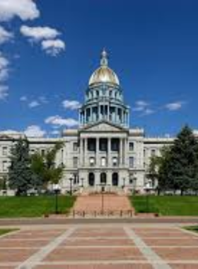 This image shows the Colorado State Capitol building, an iconic government landmark in Denver with its stunning golden dome and grand exterior. Visitors can explore the historical significance of the Capitol, take free tours, or simply admire the impressive architecture. The view from the Capitol's steps offers breathtaking views of downtown Denver and the nearby Rocky Mountains. It’s an important cultural site and a great place to learn about the history and politics of Colorado while taking in the city's scenic beauty.