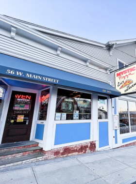 This image shows Mystic Pizza, the famous pizzeria from the 1988 movie starring Julia Roberts. Known for its delicious pizza and movie memorabilia, the restaurant attracts both film buffs and pizza lovers. Visitors can dine on cheesy pizza while enjoying the nostalgia of the movie’s iconic scenes. The restaurant’s fun atmosphere and delicious food make it a must-visit for fans of the film and anyone looking for great pizza.