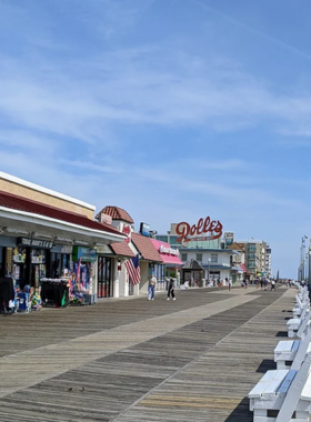 1. Relax on the Rehoboth Beach Boardwalk This image shows that the Rehoboth Beach Boardwalk is a historic and lively destination with ocean views, shops, and a vibrant atmosphere. People are seen walking along the boardwalk while enjoying the sunny day. This popular spot offers a relaxed beach vibe, ideal for leisurely strolls, grabbing a bite, or simply enjoying the beautiful ocean breeze.