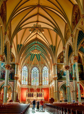 This image shows the majestic Cathedral of St. John the Baptist in Savannah, Georgia, with its towering spires and intricate stained-glass windows. The architectural beauty of the cathedral is showcased against the backdrop of the city’s skyline. Visitors come to admire the stunning craftsmanship and serenity of the church, making it a must-visit landmark for those appreciating history, art, and religious architecture in Savannah.