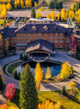  This image shows that Sun Valley Resort is a premier destination for skiing enthusiasts, offering world-class slopes for all skill levels. The scene features skiers gliding down the mountain, with a backdrop of majestic snow-capped peaks and clear blue skies. Sun Valley is known for its winter sports, attracting professional skiers and families alike. The resort’s rich history, dating back to 1936, is celebrated here, making it one of the best places in the U.S. for winter sports, from skiing to snowboarding.
