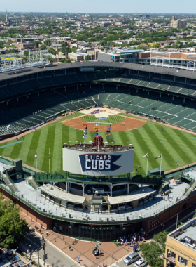 A vibrant crowd at Wrigley Field cheering for the Chicago Cubs during a baseball game.