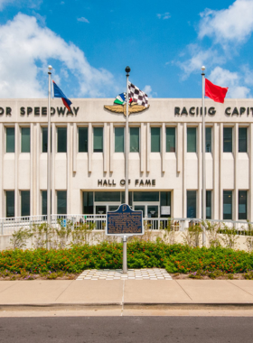  This image shows the iconic Indianapolis Motor Speedway, a historic racing venue that hosts the prestigious Indy 500 race. The image captures the speedway's vast track, with the famous brick surface and grandstands in the background. Visitors can explore the Indianapolis Motor Speedway Museum, where they can view classic race cars, learn about the history of motorsport, and take guided tours of the legendary racing track. It is one of the most significant motorsport destinations in the world, attracting racing enthusiasts year-round.