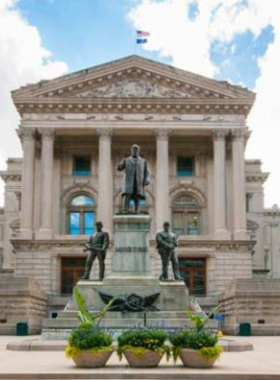 This image shows the Indiana State Capitol, an architectural marvel in Indianapolis, where the state’s government operates. The Capitol building features intricate details and a large dome that stands out against the city skyline. Visitors can tour the building to learn about the legislative process, explore the chambers, and appreciate the impressive design. The interior is beautifully decorated, with murals and historical artifacts reflecting Indiana’s political history. It’s a must-visit destination for those interested in the state’s government and rich heritage.