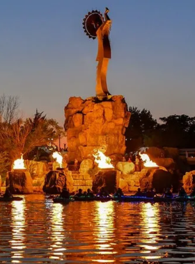 This image shows the Keeper of the Plains, a 44-foot tall Native American statue located in Wichita, Kansas. The sculpture represents the spiritual connection between the land and the people. Set at the confluence of two rivers, the statue is an iconic symbol of the region. At night, fire pots are lit, adding to the mystical ambiance. This landmark is a significant piece of local culture and history and a perfect spot for reflection and serenity.