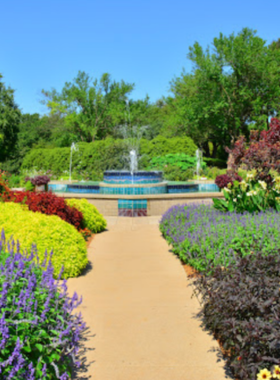 This image shows Botanica Wichita, a beautiful botanical garden located in the city. With over 30 themed gardens, including butterfly gardens and sensory gardens, it offers a peaceful escape for nature lovers. Visitors can enjoy the stunning floral displays, peaceful walking paths, and seasonal events. Botanica is perfect for those looking to relax and reconnect with nature while learning about various plants and conservation efforts.