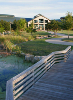 This image shows the Great Plains Nature Center in Wichita, Kansas, a natural haven for outdoor enthusiasts. The center offers over 240 acres of hiking trails, wetlands, and wildlife viewing areas. It provides a peaceful environment where visitors can learn about the local ecosystem, spot various bird species, and enjoy nature walks. The center also hosts educational programs for all ages, making it a great spot for families and nature lovers to explore.