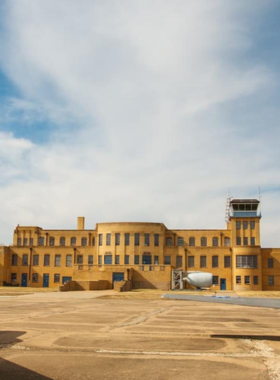 This image shows the Kansas Aviation Museum, located in Wichita, Kansas, a city known for its rich aviation history. The museum showcases a wide variety of historic aircraft and aviation exhibits, celebrating Wichita’s role in the development of aviation. Visitors can explore vintage planes, interactive exhibits, and learn about the pioneers who shaped the skies. It's an educational experience for aviation enthusiasts and families interested in learning about flight history.