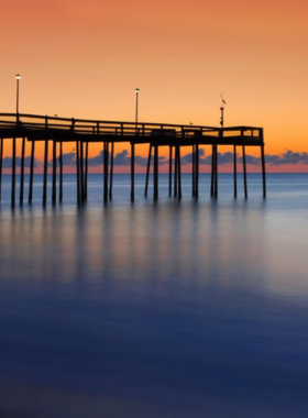 This image shows anglers fishing from the Ocean City Pier, a popular spot for both seasoned fishermen and beginners. The pier juts out into the ocean, offering a perfect view of the water and surrounding coastline. People are seen casting their lines into the deep waters while enjoying the fresh ocean breeze. The sound of the waves and the peaceful ambiance make it a relaxing experience. The pier has been a key part of Ocean City’s fishing tradition for decades."