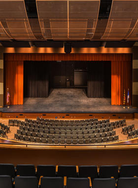 This image shows the Ocean City Performing Arts Center, where visitors gather to enjoy live entertainment. The stage is set for a performance, and the audience is seen seated in an intimate theater space, awaiting the show. The venue hosts a variety of events, including theater productions, concerts, dance performances, and comedy shows, attracting both locals and tourists. The center is an important cultural spot in Ocean City, offering top-notch performances and a cozy, welcoming atmosphere for all."