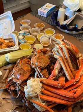 This image shows a plate of freshly prepared seafood, including crab cakes, shrimp, and oysters, served at a popular Ocean City restaurant. The seafood is arranged beautifully, with vibrant colors and garnishes that highlight its freshness. Visitors can indulge in a variety of seafood dishes, enjoying the flavors of the ocean and experiencing the local cuisine. Ocean City’s restaurants serve the best of Maryland’s coastal flavors, making it a haven for seafood lovers and culinary adventurers."