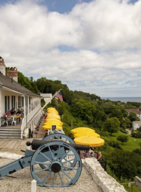 This image shows Fort Mackinac, a historic military outpost on Mackinac Island, built in the late 1700s. The fort offers a glimpse into the past with its exhibits, reenactments, and live demonstrations of military life during the War of 1812. Visitors can explore the fort’s cannon-lined walls, old barracks, and commanding views of the island. A visit here takes you back in time and educates you about the island’s strategic importance during America’s early years.