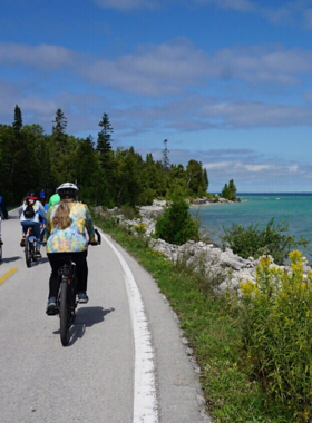 This image shows a group of visitors enjoying a bike ride around Mackinac Island’s scenic pathways. The island’s flat terrain and ban on motor vehicles make it the perfect place to explore by bike. You can ride past historic sites, charming Victorian homes, and spectacular waterfront views. Biking is one of the best ways to see all the island has to offer at your own pace, with bike rentals available throughout the island. It’s an easy, fun, and eco-friendly way to travel.