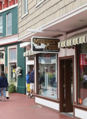 This image shows visitors sampling the famous fudge at Murdick’s Fudge Shop on Mackinac Island. The island is known for its sweet, creamy fudge, and Murdick’s is one of the oldest and most beloved fudge shops. Watch as the fudge is made right in front of you, and choose from a variety of flavors such as chocolate, caramel, and peanut butter. The fudge is a must-try treat for anyone visiting Mackinac Island, and it makes for a sweet souvenir.