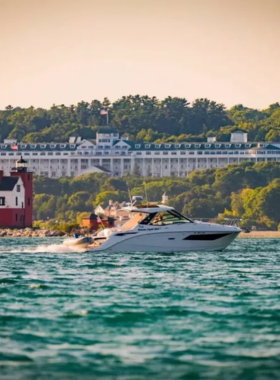 This image shows a scenic boat ride around Mackinac Island, offering stunning views of the island's lush landscape, pristine waters, and the iconic Mackinac Bridge. The boat tour provides visitors with an opportunity to see the island from a unique perspective, with panoramic views of the surrounding area. Whether you're looking to relax or take in the breathtaking views, the boat ride is a great way to explore Mackinac Island’s scenic beauty from the water.