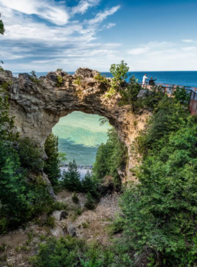 This image shows a panoramic view of Mackinac Island State Park, one of Michigan’s most beautiful and expansive parks. The park covers over 80% of Mackinac Island and is home to scenic hiking and biking trails, historic sites, and diverse wildlife. Visitors can enjoy outdoor activities such as horseback riding, picnicking, and nature walks while exploring the park’s lush forests and peaceful lakeshores. It’s a natural haven for adventure lovers and nature enthusiasts alike.