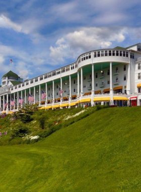 This image shows the iconic Grand Hotel on Mackinac Island, a luxurious destination known for its Victorian charm and breathtaking views. Opened in 1887, the Grand Hotel is one of the island’s most famous landmarks. Visitors can explore the hotel’s historic grounds, relax on the world’s longest porch, or enjoy fine dining at its renowned restaurants. The Grand Hotel offers a timeless experience, combining elegance with unmatched natural beauty.