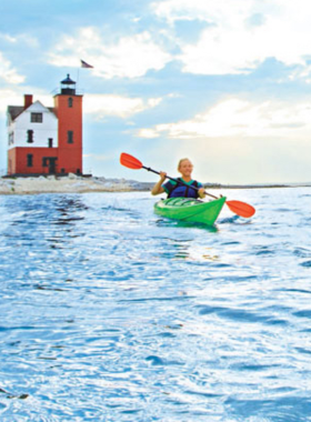 This image shows visitors kayaking around Mackinac Island, taking in the peaceful waters and stunning coastline. Kayaking is an adventurous way to experience the island’s natural beauty up close, as you paddle past hidden coves and pristine beaches. Whether you're a beginner or experienced, kayaking around Mackinac Island provides a unique perspective of the island’s coastline and offers a chance to spot local wildlife such as birds and fish. It’s an exciting and serene activity for nature lovers.