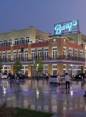 This image shows a lively street in Downtown Biloxi, lined with art galleries, murals, and street vendors selling handmade crafts. Musicians are playing live music, and people are browsing through paintings and sculptures. The colorful atmosphere reflects Biloxi’s vibrant arts and culture scene.