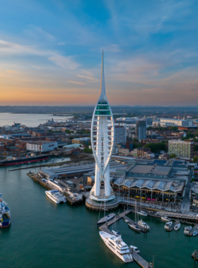 This image shows the iconic Spinnaker Tower in Portsmouth, a modern architectural marvel offering stunning views of the city and coastline. Visitors can enjoy breathtaking panoramic views from the observation deck, 170 meters above the ground. The tower also features a glass floor for an exciting, adventurous experience. It's one of the best places to see Portsmouth and its beautiful harbor from above, making it a must-visit attraction for both locals and tourists.