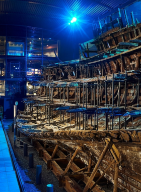 This image shows the Mary Rose Museum in Portsmouth, showcasing the preserved remains of the famous Tudor ship, the Mary Rose. The museum offers visitors a chance to learn about life aboard the ship, which sank in 1545. Visitors can see a variety of artifacts recovered from the ship, including personal items, weapons, and tools, all displayed in a state-of-the-art exhibit. It's a fascinating look into the maritime history of the Tudor period, making it an educational experience for all ages.