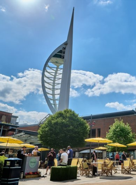 This image shows Gunwharf Quays, a vibrant shopping center in Portsmouth with a mix of outlet stores, restaurants, and entertainment. With stunning views of the harbor, visitors can enjoy shopping for fashion, accessories, and gifts while taking in the beautiful surroundings. Gunwharf Quays is also known for its wide range of dining options, making it an ideal spot for a full day out. Whether you're shopping or just enjoying a meal, this destination offers a modern and lively atmosphere.