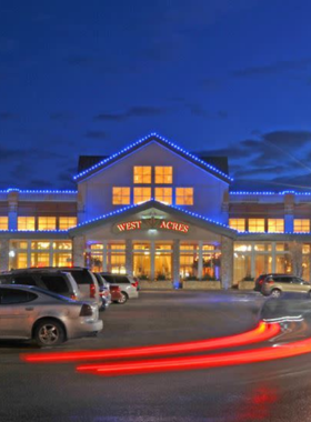 This image shows the West Acres Mall, the largest shopping center in North Dakota, filled with fashion stores, electronic shops, and dining options. Shoppers are seen carrying bags, browsing through storefronts, and enjoying the mall’s indoor art gallery and aquarium. The modern design, bright lighting, and spacious walkways make it a popular destination for both locals and tourists looking for retail therapy and entertainment.