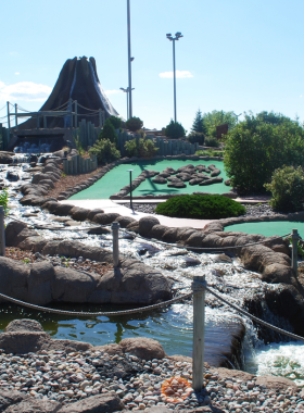 This image shows Thunder Road Family Fun Park, featuring go-karts racing around a winding track, kids playing mini-golf, and families enjoying arcade games. Brightly colored rides and attractions create a lively and energetic atmosphere. The park is a great place for thrill-seekers and families to have an exciting day filled with fun activities in Fargo.