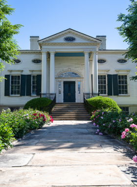 This image shows the historic Taft Museum of Art, a beautifully preserved 19th-century mansion with a white-columned facade and elegant gardens. The museum is home to an impressive collection of European and American masterpieces, including works by Rembrandt and Goya. The interior features classic decor, intricate woodwork, and intimate gallery spaces filled with stunning paintings and sculptures. Visitors can enjoy a peaceful walk through the museum’s lush garden area, sip coffee at the cozy café, and admire the timeless beauty of art in an intimate and historic setting.