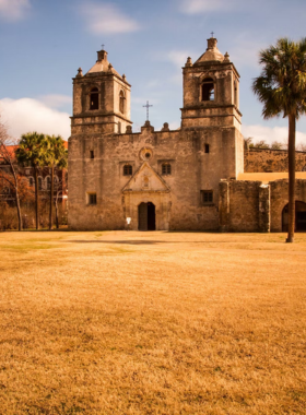 This image shows the breathtaking beauty of the San Antonio Missions National Historical Park, featuring the well-preserved stone structures of Mission Concepción. The surrounding green fields, clear blue sky, and ancient walls create a peaceful atmosphere. Visitors are seen walking the scenic trails, learning about Spanish colonial history, and admiring the historic churches that have stood for centuries.