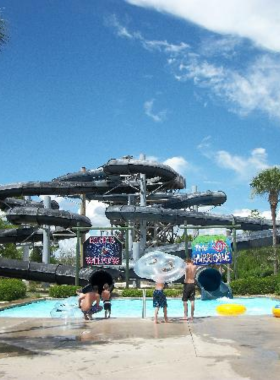 This image shows the thrilling and fun-filled atmosphere at Waterville USA in Gulf Shores. The image features people sliding down exciting water slides, while others relax in the lazy river or enjoy the wave pool. The park offers a mix of water attractions and amusement rides, making it a perfect family destination. The laughter and excitement in the air show how much fun visitors have at this top-notch water park.